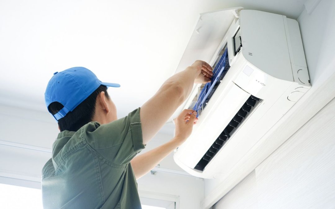 Air conditioning technician maintaining an indoor mini split system in Evans, CO